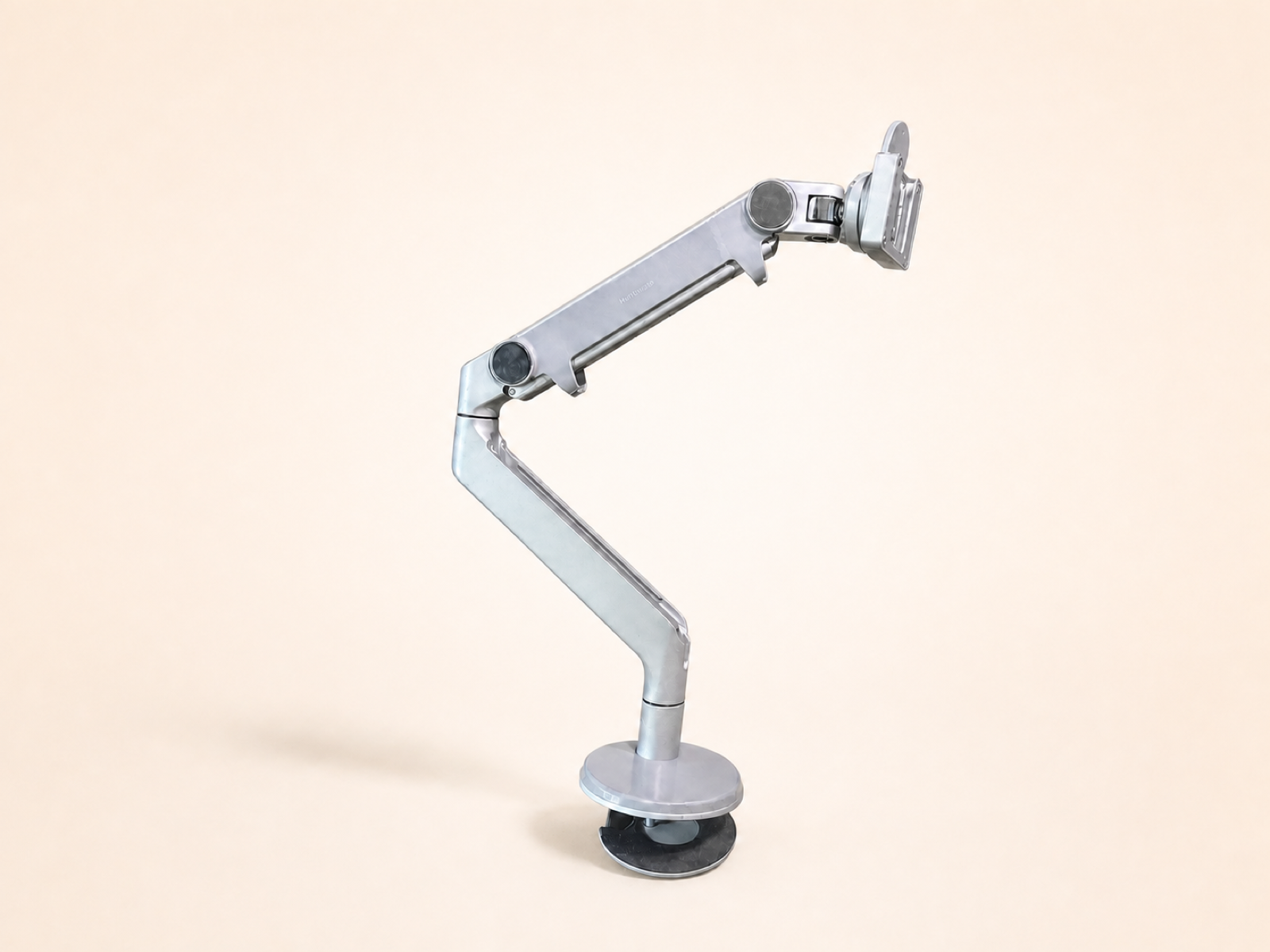 Silver Humanscale adjustable monitor arm.